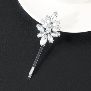 Detail of silver hair clip with sparkling marquise crystal flowers on black leather base