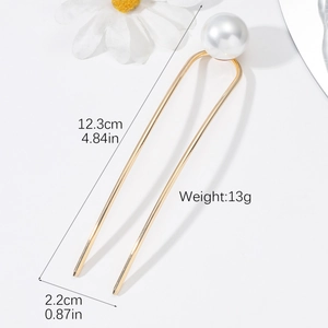 Detail view of U-shaped gold hair pin with large white pearl showing 12.3cm length