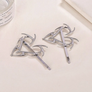 Detailed macro shot of silver gothic fire pattern hair clips with polished finish
