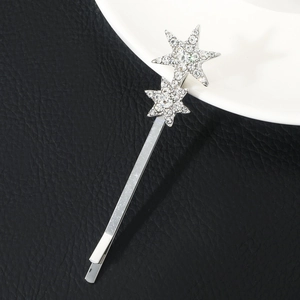 Detailed view of silver bobby pin with sparkling rhinestone star decorations on black leather