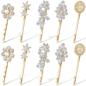 10-piece gold hair clip set with rhinestone sun, star, and leaf designs on white background