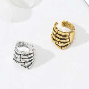 Detail of gothic skull hand rings in gold and silver finishes with adjustable band