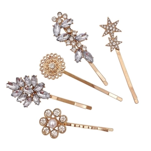 Golden hair clip set with rhinestones featuring stars, flowers and leaf patterns