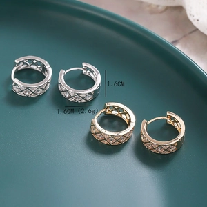 Detail view of 1.6cm geometric rhombus hoop earrings with cubic zirconia in gold and silver