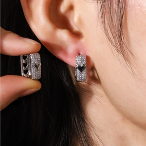 Sparkling pavé hollow heart hoop earrings in polished silver with micro-pave crystals