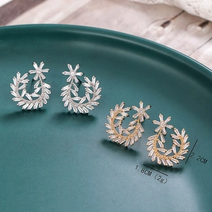 Detail view of Greek leaf earrings with dimensions 2.2cm x 1.8cm in gold and silver finish