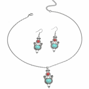 Vintage silver jewelry set featuring turquoise pendants and metal fringe earrings on white background