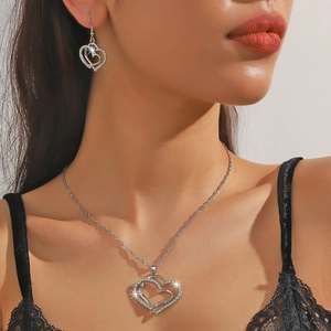 Elegant silver heart jewelry set featuring hollow diamond-encrusted necklace and earrings