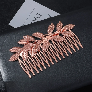 Detailed macro shot of a rose gold leaf hair comb for elegant bridal updo hairstyles