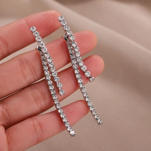 Detail view of elegant S925 silver fringe earrings with sparkling round diamonds