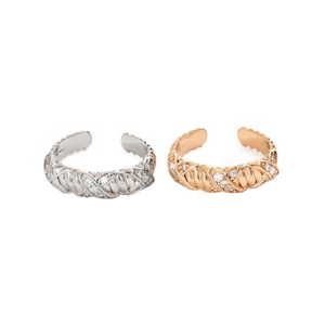 Detail view of woven chain rings in silver and rose gold with micro-set zircons