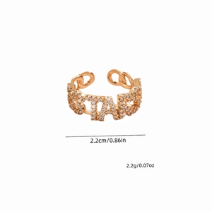 Detail view of gold adjustable ring with STARS lettering and cubic zirconia paving