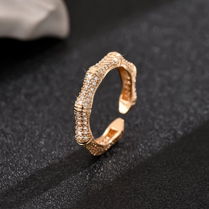 Detail of bamboo joint design ring with white zircon pave setting in golden finish