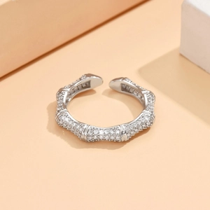 Detailed close-up of a silver-toned open ring with sparkling bamboo joint segments