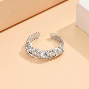 Detail of silver-colored chain-braided open ring with sparkling round cubic zirconia