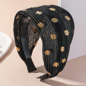 Detail of wide black headband with gold glitter patterns and non-slip inner teeth design