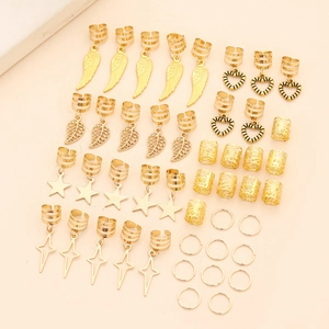 Detailed macro view of gold alloy hair charms featuring leaf, star and feather pendants