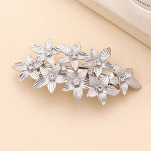 Elegant silver flower hair clip with seven crystal-encrusted petals and metal texture