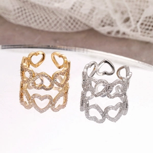 Eleganti anelli aperti a cuore dorati e argentati con pavé di zirconi e riflesso a specchio