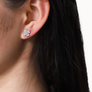 Sparkling silver cross star stud earrings with brilliant zircon stones worn by a model