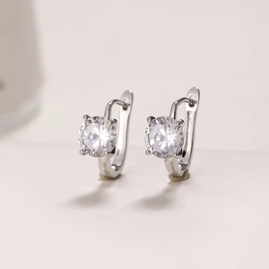 Detailed macro view of silver four-prong U-shaped earrings with round brilliant stones