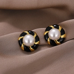 Vintage gold-plated earrings with black enamel spiral and round faux pearl on silk