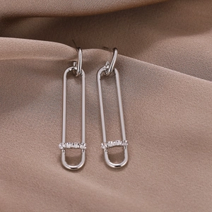 Elegant silver-toned paperclip drop earrings with pave zircon accents on satin fabric