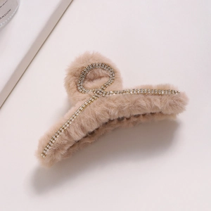 Plush faux fur hair claw clip with rhinestones and chain detail in beige color