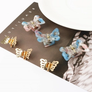 Set of six mini butterfly hair clips in gold metal and marble acrylic finishes