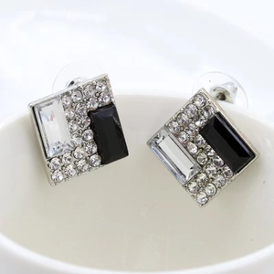 Detailed close-up of square geometric clip-on earrings with black and white zircon crystals