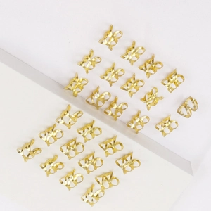 Set of 24 gold hollow metal hair rings for dreadlocks and braids on white background