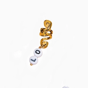 Golden spiral hair ring with white alphabet beads showing letters L and O for dreadlocks