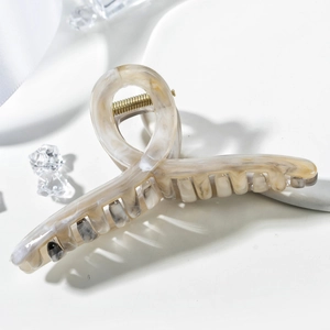 Elegant large marble textured hair claw clip in beige and grey with gold spring