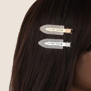Pair of sparkling rhinestone hair clips in gold and silver finish for women's hairstyles