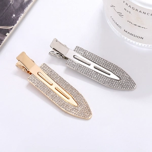 Close-up of sparkling rhinestone duckbill hair clips in gold and silver metal finish