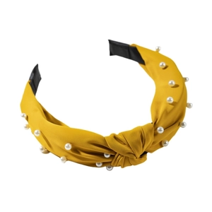 Chic knotted cross headband in bright yellow fabric with elegant white faux pearl accents
