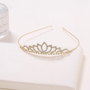 Detailed side view of a bridal crown with golden alloy base and sparkling rhinestones