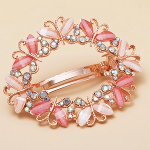 Elegant rose gold butterfly spring hair clip with pink resin wings and sparkling crystals