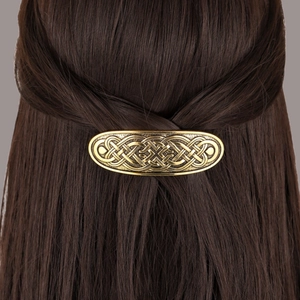 Vintage gold Celtic knot hair clip for women styled on elegant long brown hair
