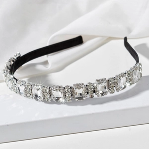 Detailed macro view of luxury headband featuring large rhinestones on black fabric
