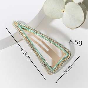 Detail view of 6.5cm triangle snap clip with mint green beads and sparkling rhinestones