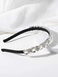 Close-up of elegant headband with rectangular crystals and rhinestones on black metal frame