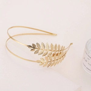 Close-up of a double-layered golden leaf headband with detailed metallic feathers
