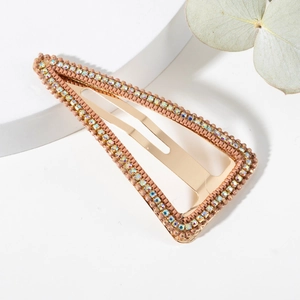Close-up of triangle BB hair clip with brown beads and iridescent rhinestones on gold alloy