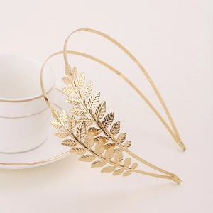 Elegant gold leaf headband accessory for bridal hair with detailed metal foliage texture