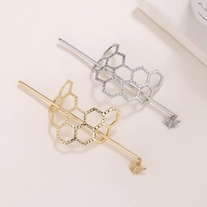 Detailed close-up of honeycomb mesh hair stick with a delicate bee pendant