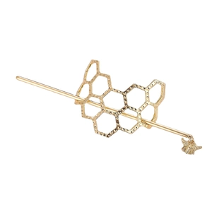 Golden honeycomb mesh hair pin with bee charm and hammered texture on white background