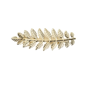 Detailed close-up of a golden metal leaf hair clip with realistic textured leaf veins