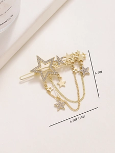 Detail of gold star hair clip with rhinestones and tassel chain measuring 6.5cm length