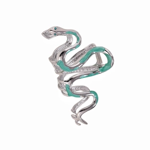 Silver snake-shaped metal hair claw clip with green enamel and jewel accents on white background